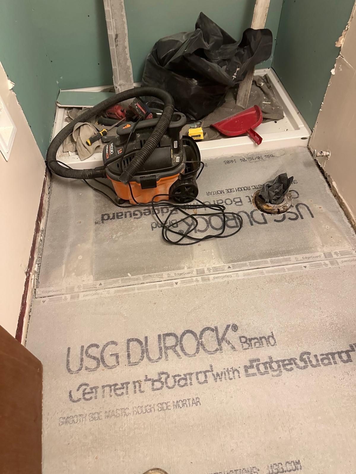 Cement backer board fastened over the bathroom subfloor before tiling