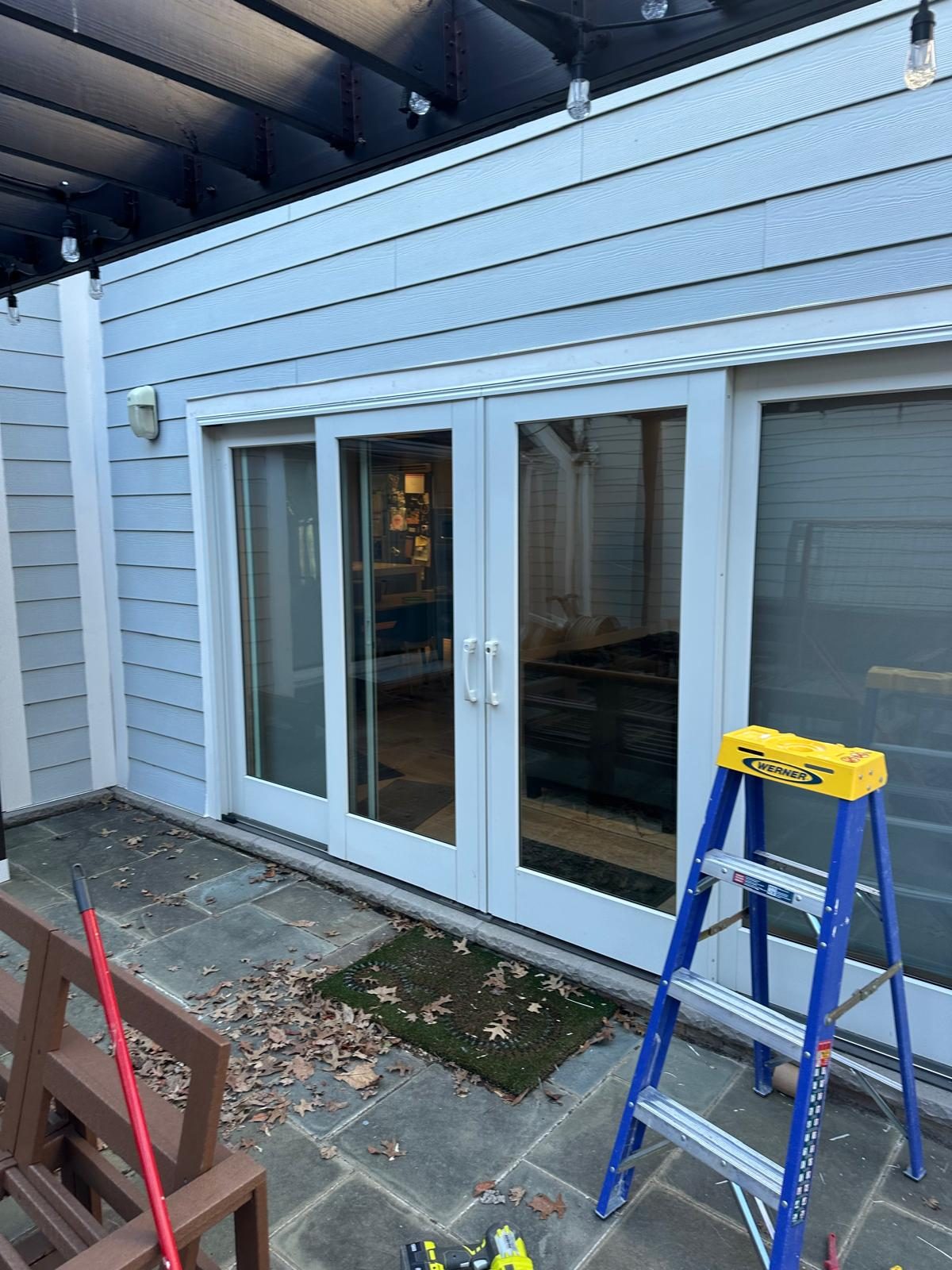 The same patio doorway finished, with exterior trim and siding closed in around the new French doors