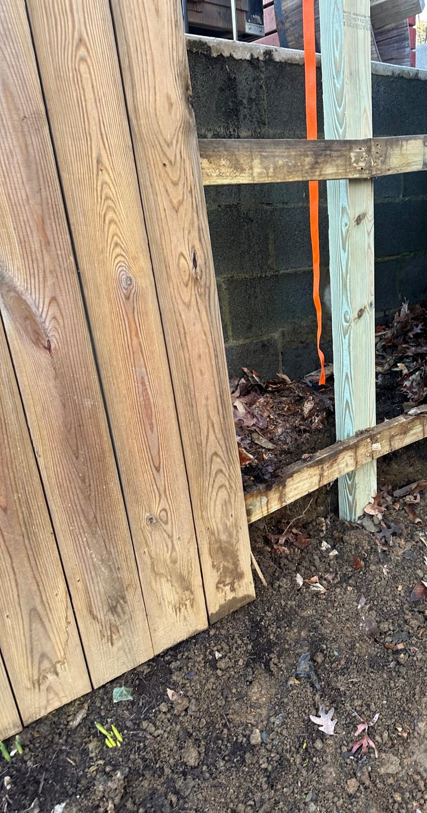 A new pressure-treated fence post plumbed and braced in the opened run