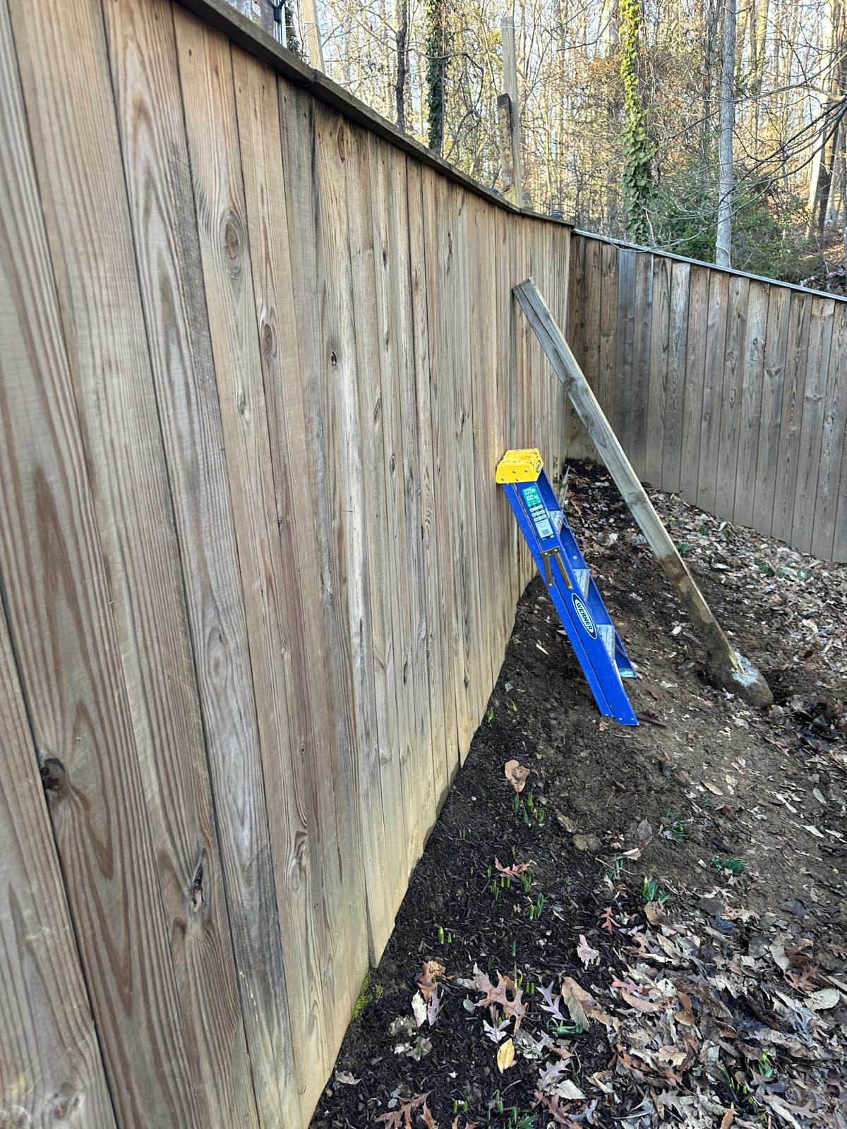 The finished fence section closed back up with the boards refastened and the line straight