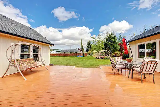 deck repair services in fairfax va featuring a professionally restored wooden deck with white railings and expert craftsmanship.