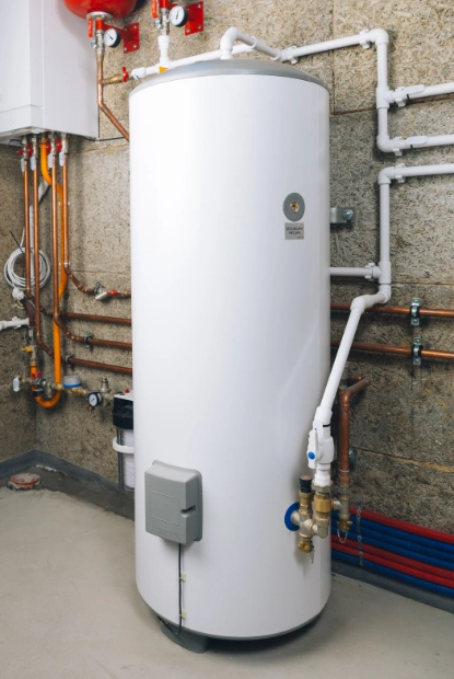 a high-efficiency white vertical boiler unit with complex copper piping, pressure gauges, and a safety expansion tank, maintained by experts in boiler repair near mclean virginia.
