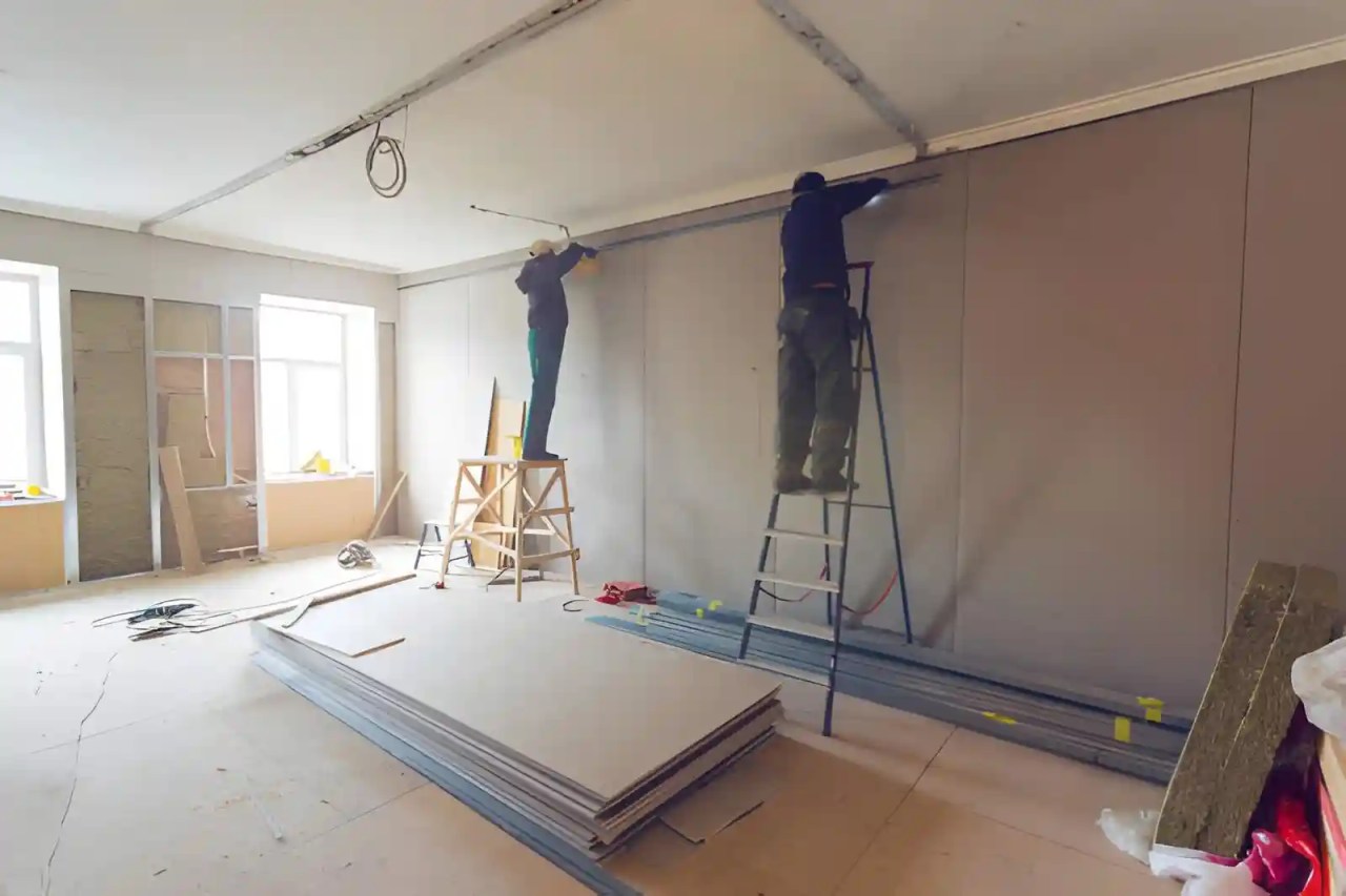 drywall patch repair in northern va with contractors installing and finishing drywall panels inside residential home