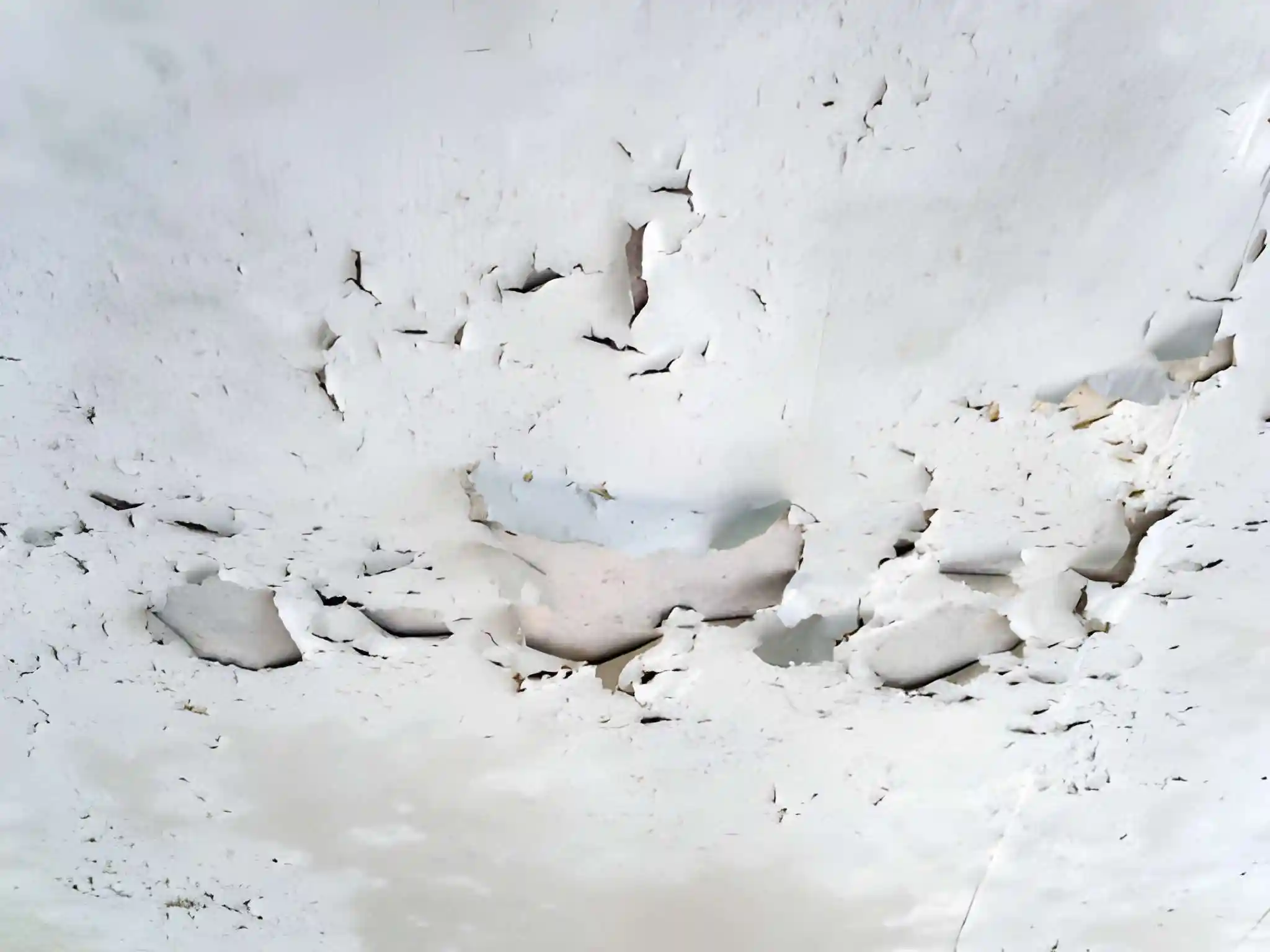 severe ceiling damage with peeling drywall caused by an emergency roof leak requiring immediate roof leak repair in centreville va