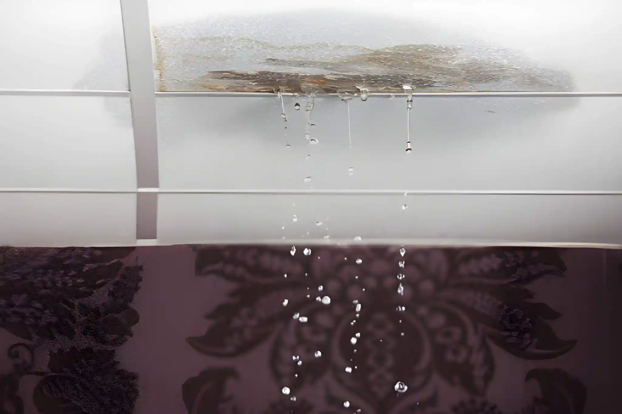 emergency roof leak repair in vienna va with water dripping from damaged ceiling tile