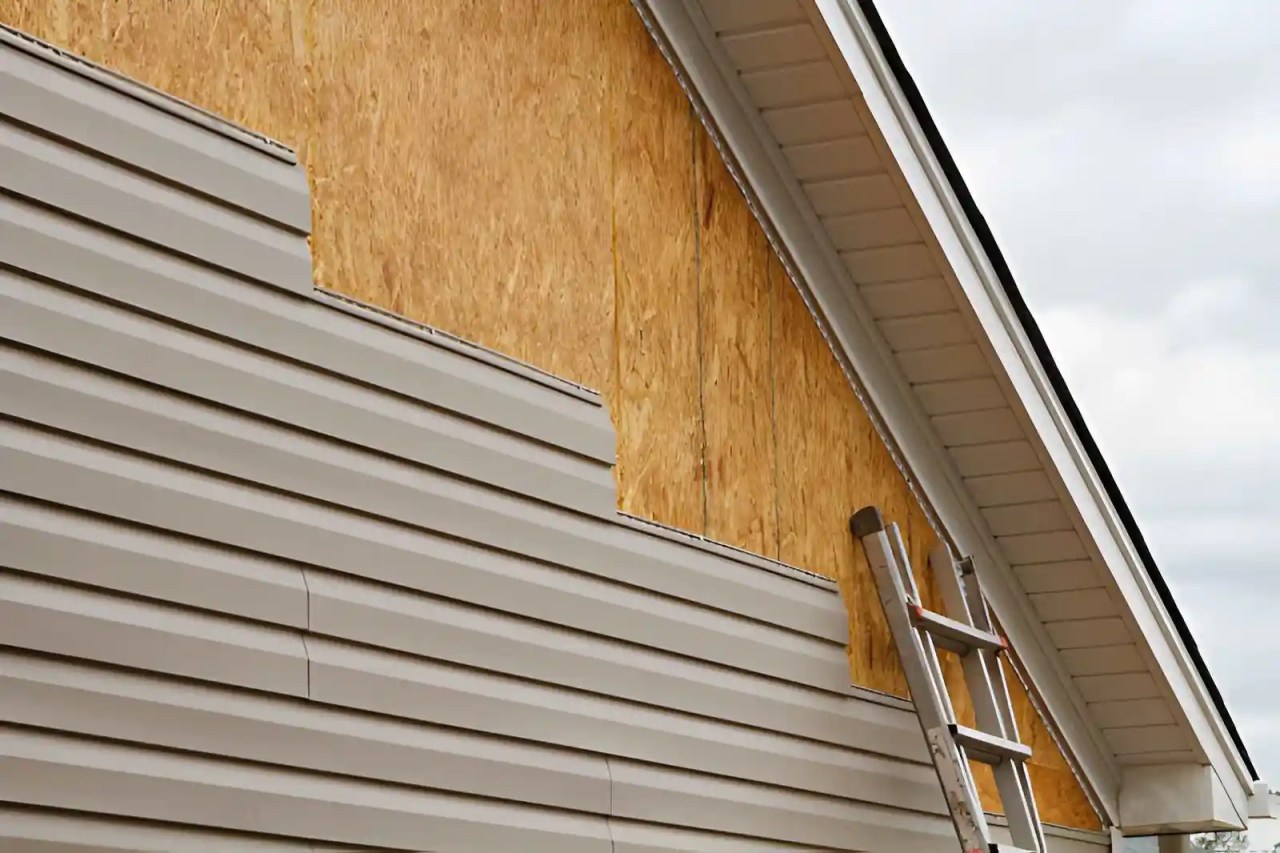 house exterior with partially removed siding showing exposed sheathing during professional siding repair.