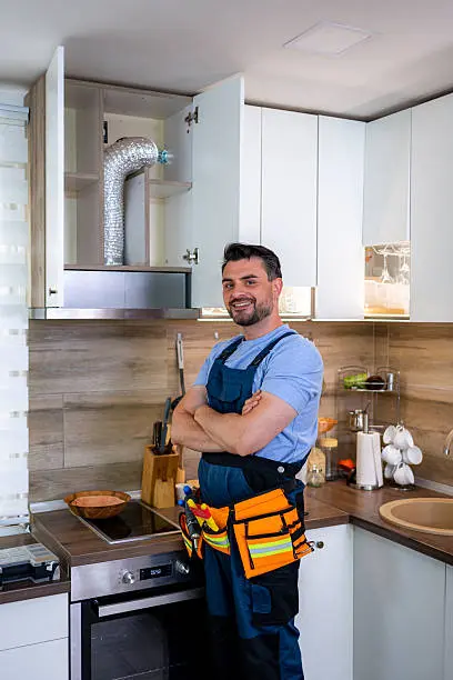 standing in a modern kitchen during home improvement service.