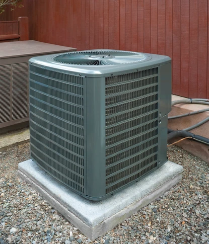 a high-efficiency grey outdoor condenser unit professionally leveled on a reinforced concrete pad as part of a heat pump installation in herndon va.a high-efficiency grey outdoor condenser unit professionally leveled on a reinforced concrete pad as part of a heat pump installation in herndon va.