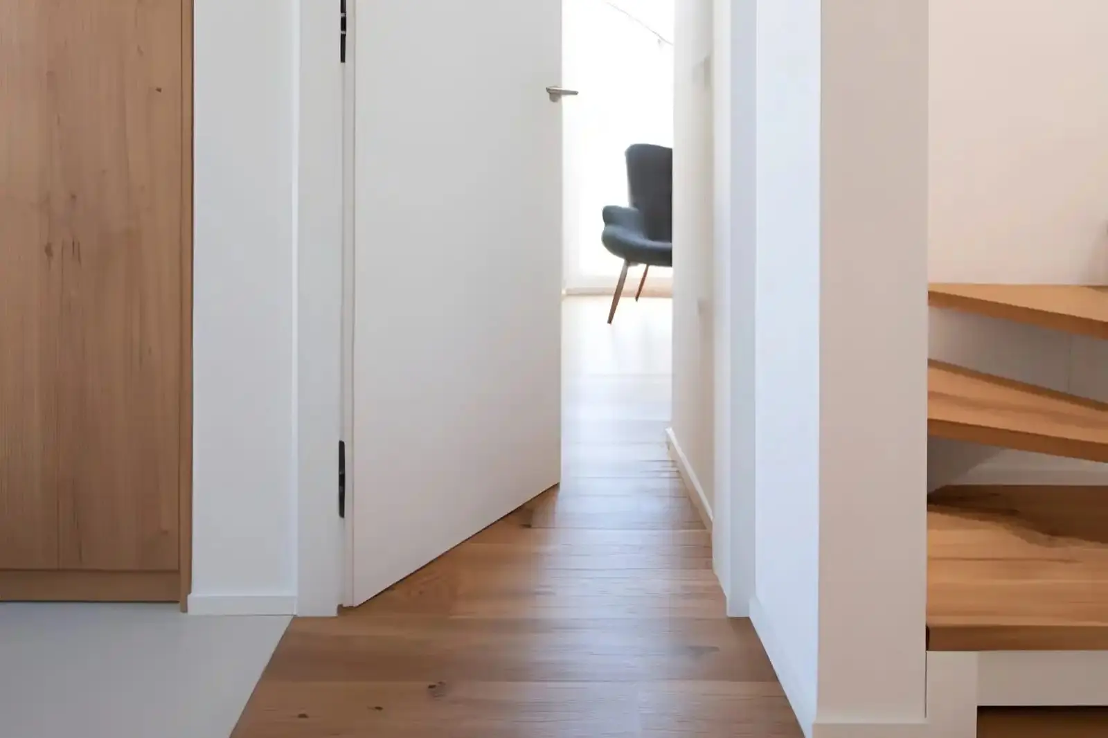 residential pocket door service in annandale va featuring interior white sliding pocket door with hardwood hallway flooring