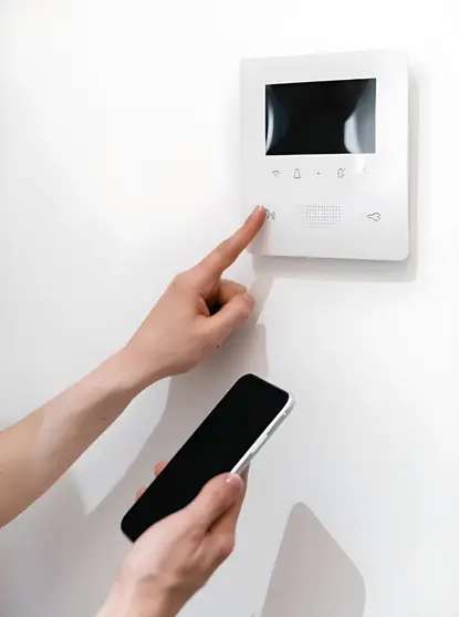 close-up of syncing a smartphone app with a new wall unit during a smart thermostat installation in vienna virginia.