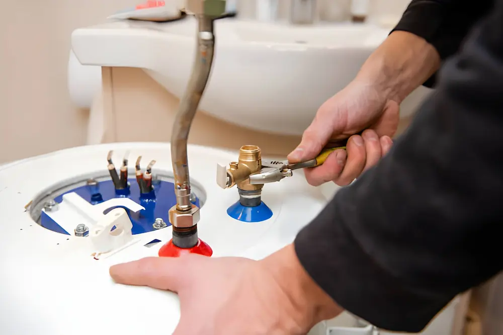 local heating repair in springfield va with a technician servicing a residential water heater valve.