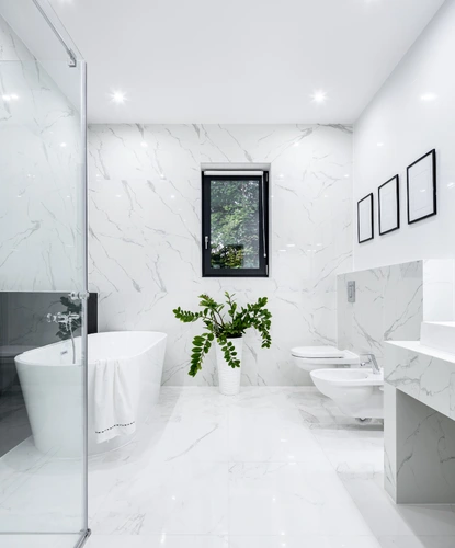 professional shower tile repair in ashburn va with tile spacers, leveling tools, and notched trowel on ceramic tiles
