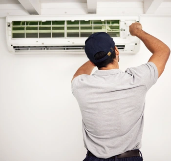 ac repair in springfield virginia technician servicing indoor air conditioning unit