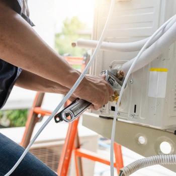 air conditioner repair in northern virginia technician servicing indoor ac unit