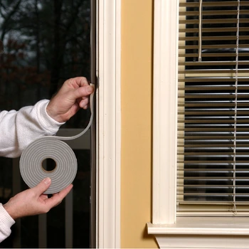 professional door weatherstripping installation in mclean va showing a technician applying a coiled foam seal to a door frame interior.