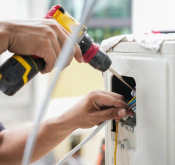 ac installation service technician connecting wiring during system installation