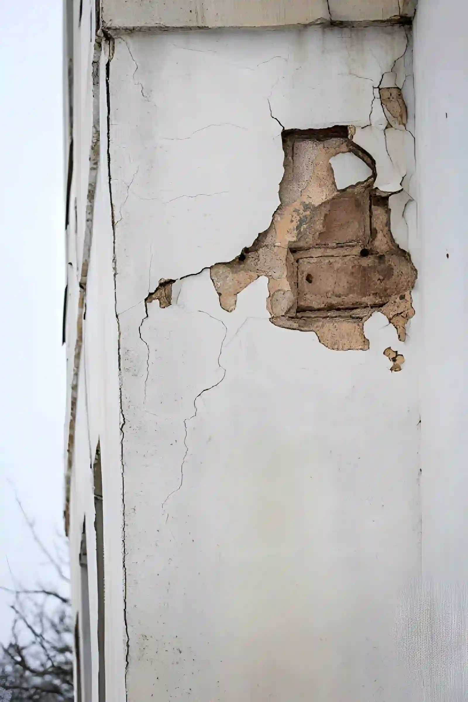 foundation inspection and repair in merrifield va showing damaged exterior wall with exposed brick and structural cracks