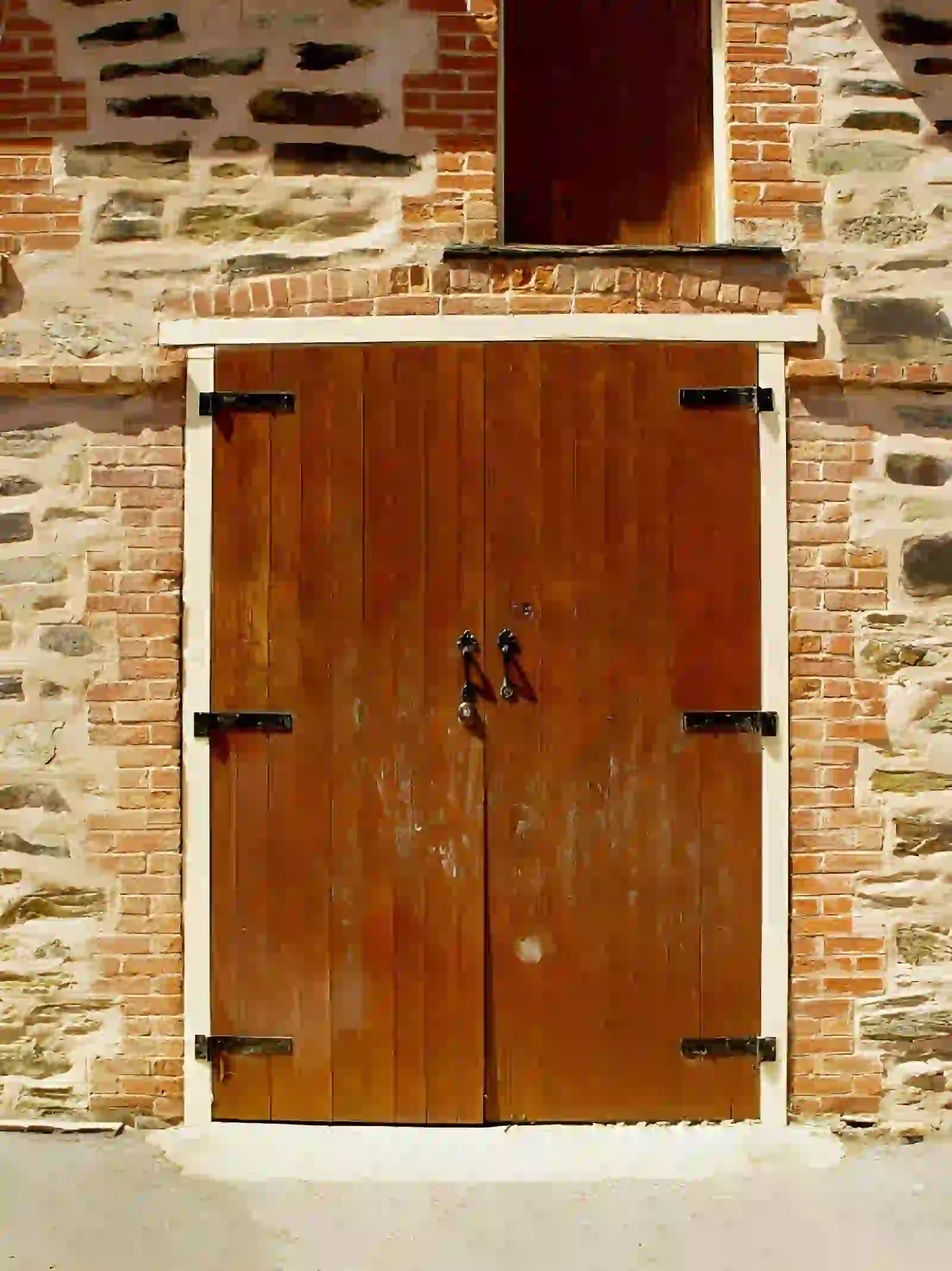 barn door repair in annandale va with wooden double doors on brick and stone exterior building