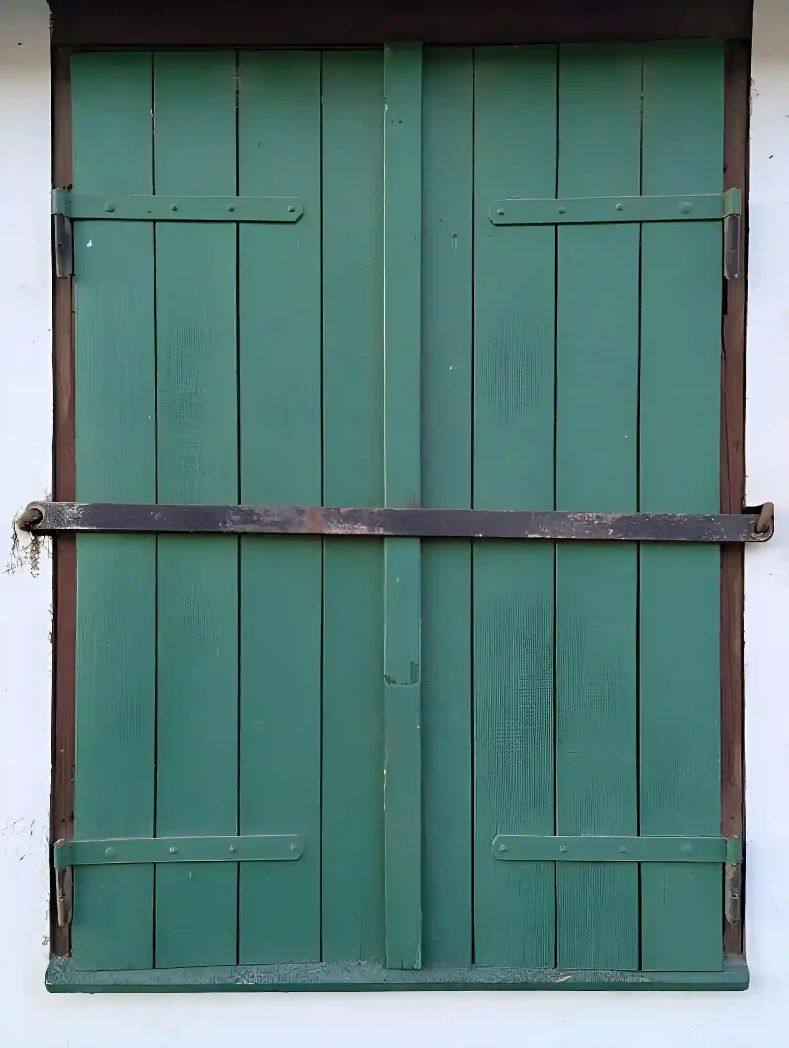 barn door repair in northern va with wooden double barn doors and exterior hardware on brick building