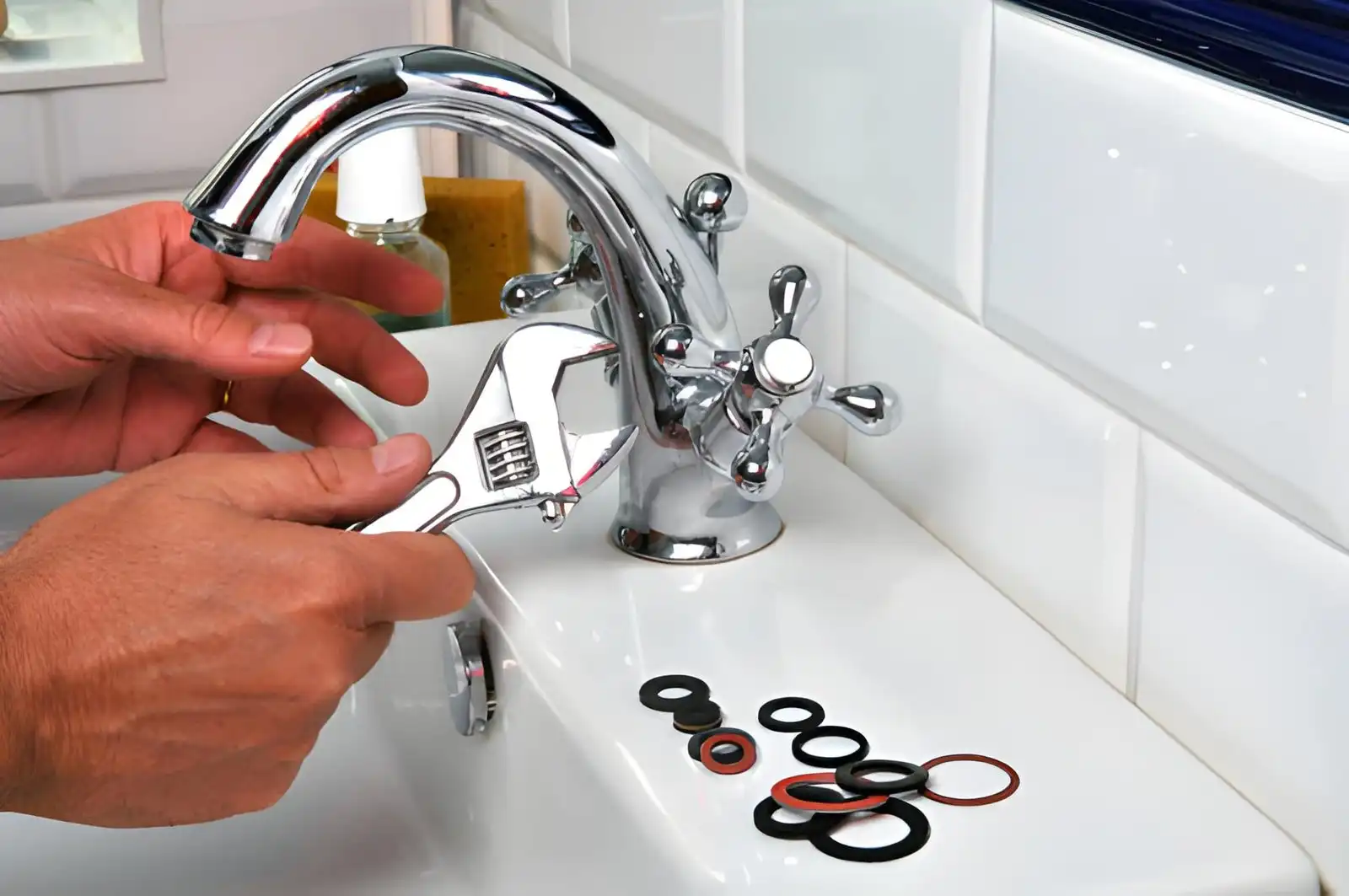 plumber repairing faucet and replacing rubber washers to fix leak and restore proper water flow. bathroom faucet repair in mclean va