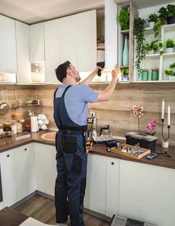 carpentry services in lorton va technician installing kitchen cabinet hardware