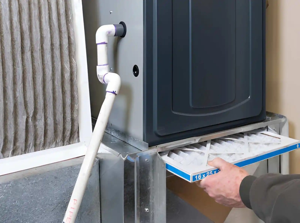 technician replacing air filter during gas furnace maintenance to improve hvac efficiency and indoor air quality. gas furnace maintenance in burke va
