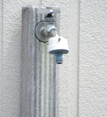 outdoor faucet with hose connection mounted on exterior wall, showing need for repair or maintenance. outdoor faucet repair in mclean va