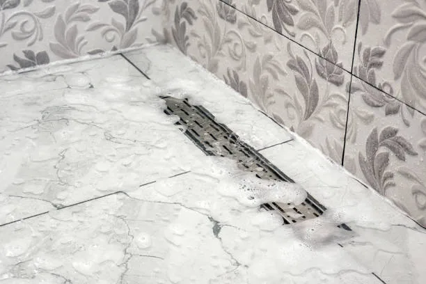 clogged shower drain with standing water and soap buildup causing slow drainage issue. clogged shower in herndon va