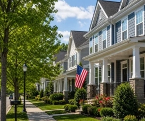 quiet residential street in fairfax county, va with modern homes, american flags, and well-maintained green lawns.