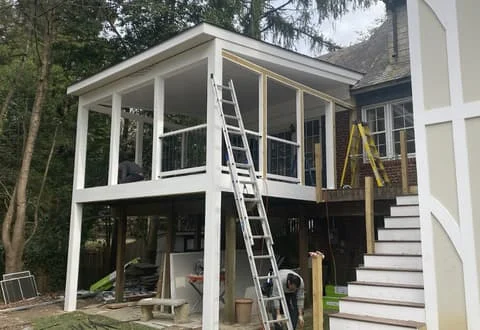 handyman service project in falls church, virginia showing elevated screened porch construction and exterior carpentry work in progress at a residential home.
