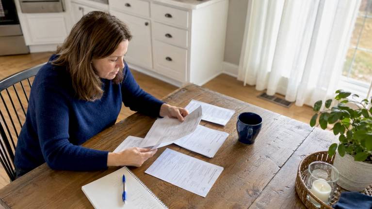 how to choose an hvac contractor in northern virginia 7 homeowner reviewing hvac contractor quotes indoors