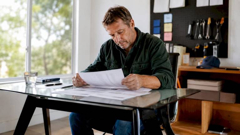 contractor reviewing warranty documents at home
