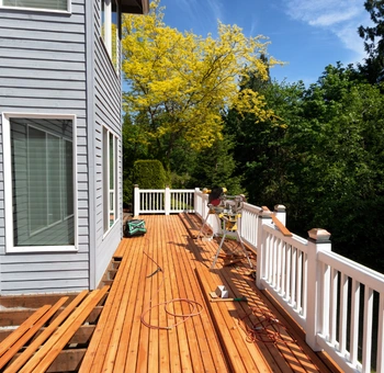 deck repair services in herndon va featuring a professionally restored wooden deck with white railings and expert craftsmanship.