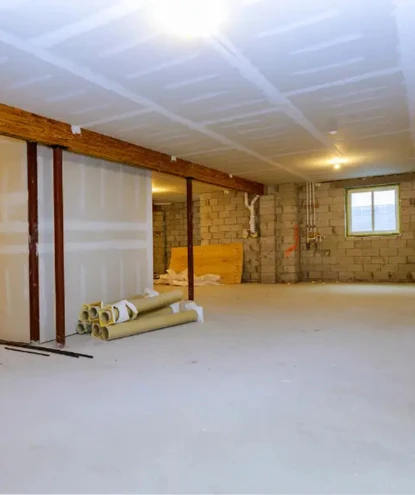 basement remodeling in lorton va 2 an unfinished lower level during structural framing and drywall installation by a basement remodeling specialist in lorton, va, showing taped ceiling drywall, concrete block walls, and exposed support columns.
