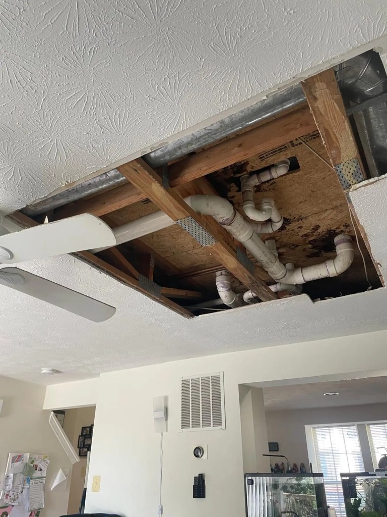 bathroom plumbing leak repair & ceiling restoration 3 bathroom plumbing leak inspection in centreville va showing ceiling opened to access damaged drain pipes
