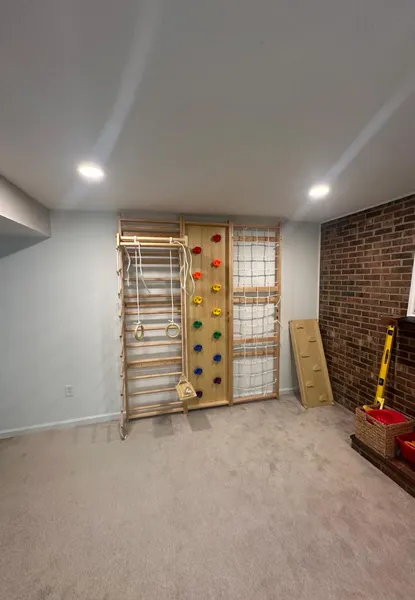 home additions in lorton va 3 interior drywall installation phase on a main partition wall completed by professional home addition contractors in lorton, va, showing crisp lines, blue joint tape, and rough-in electrical outlets.